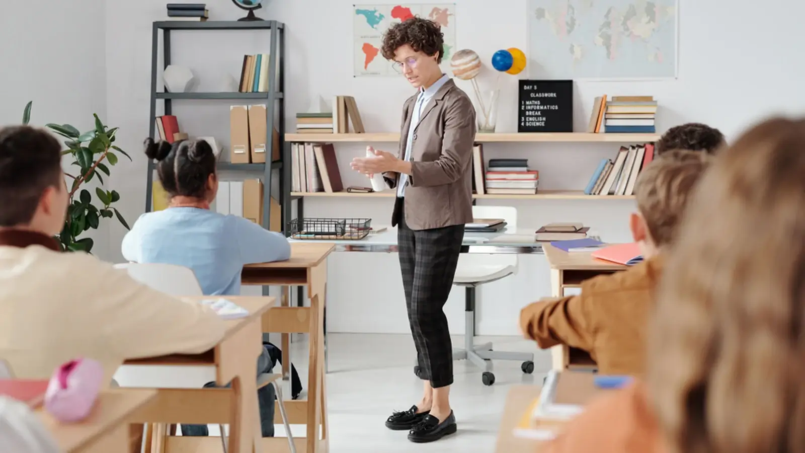 A teacher leading a classroom lesson with students, representing education and training services.