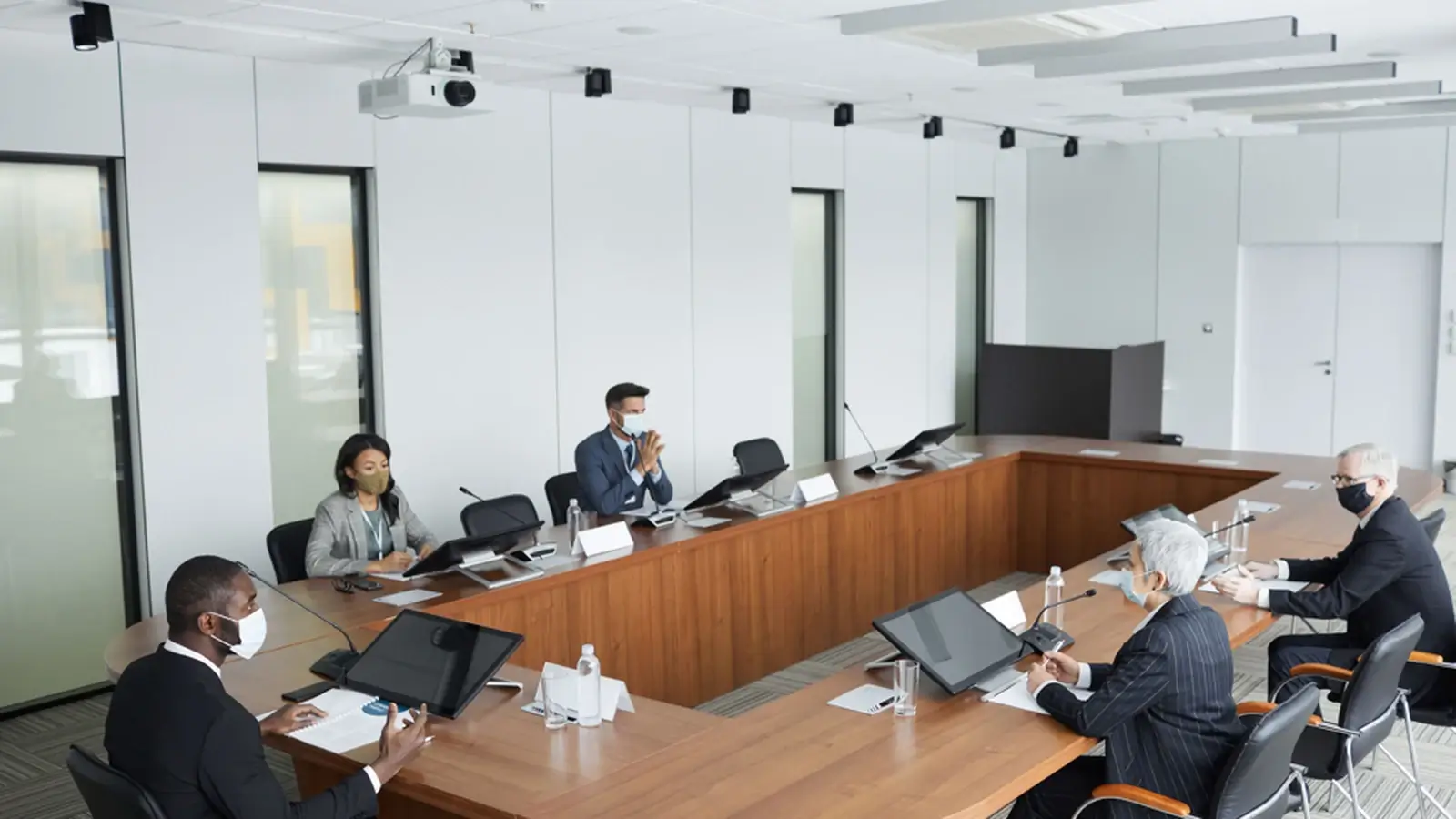 Business professionals seated around a conference table in a bright modern meeting room, representing non-technical service businesses in the USA.