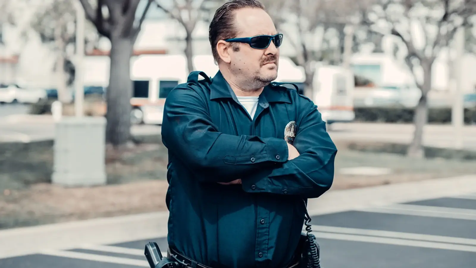 A uniformed public safety officer standing outdoors, representing public safety and government-related services.