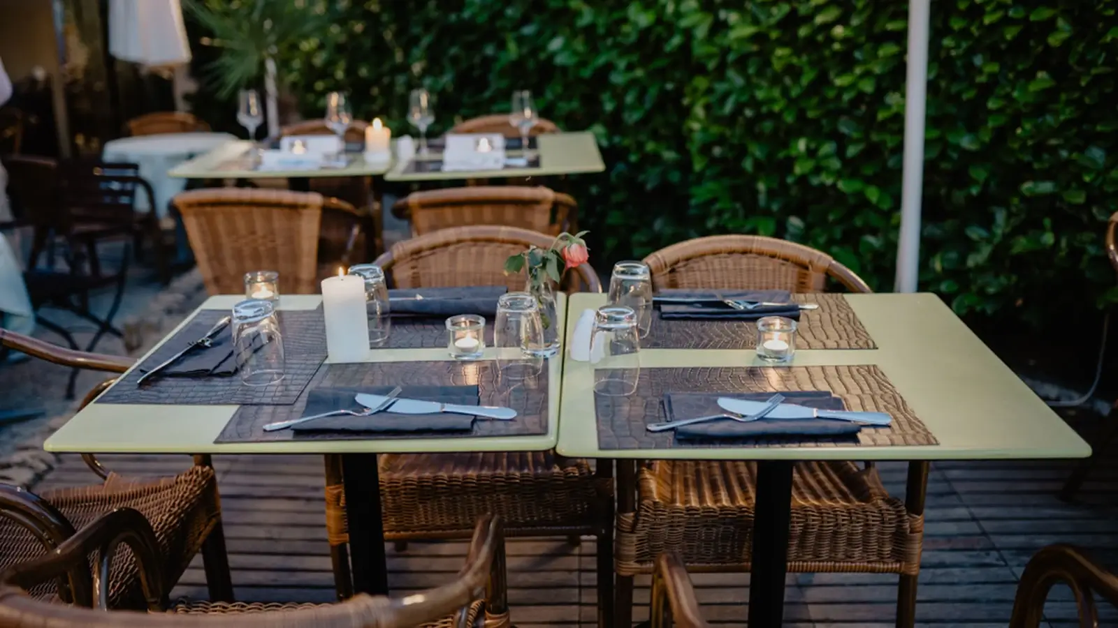 Elegant outdoor restaurant table setting prepared for guests in a hospitality environment.