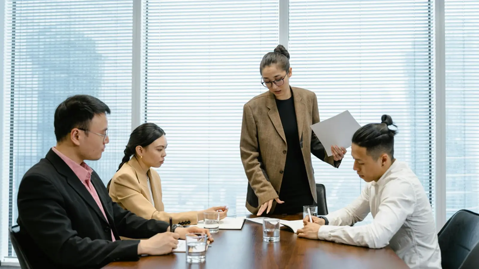 Professionals in a modern office meeting discussing strategy for a service business launch.