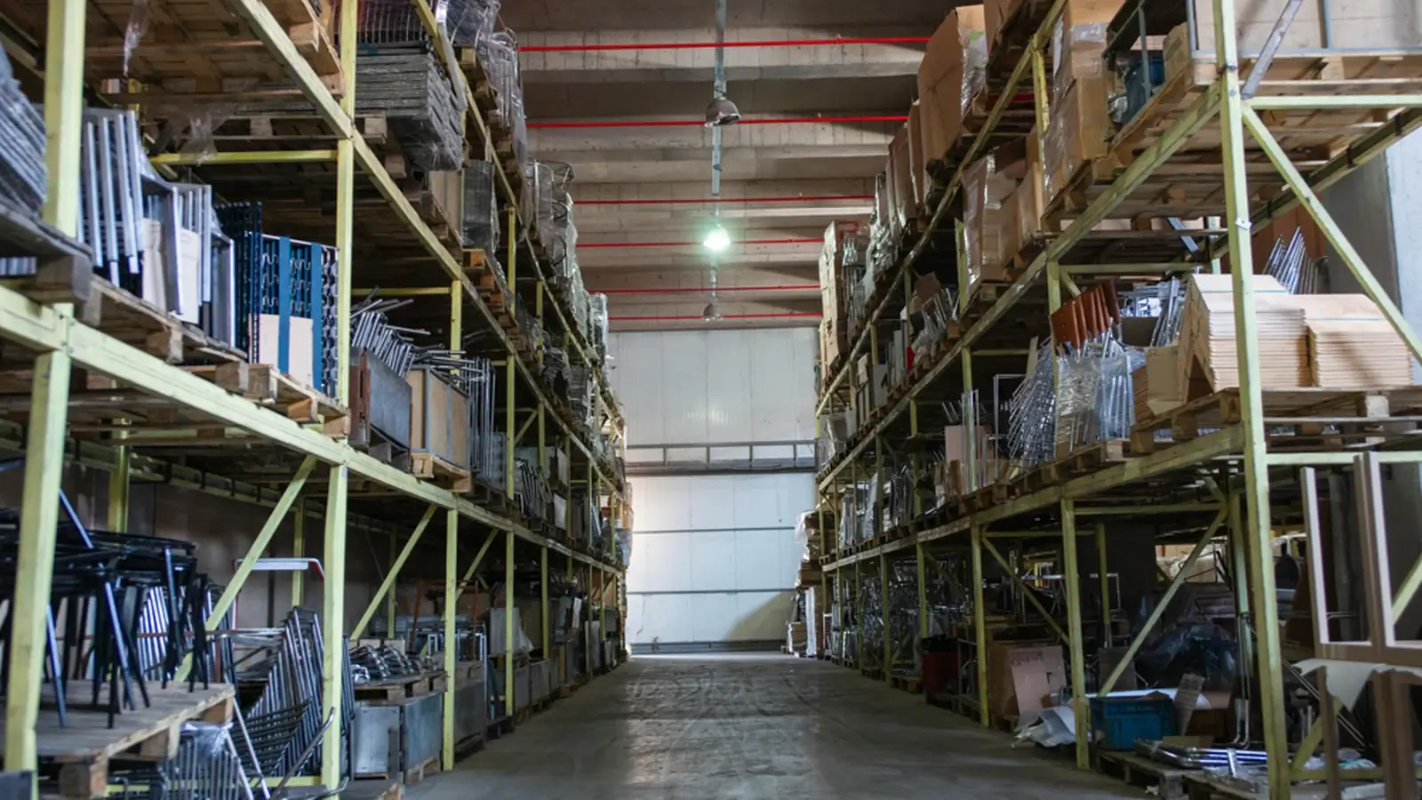 Wide warehouse storage aisle with industrial shelving, suitable for logistics and fulfillment services.